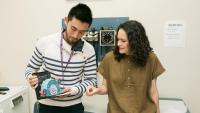 Medical students, Sean and Bianka, look at a diagram on HIV.